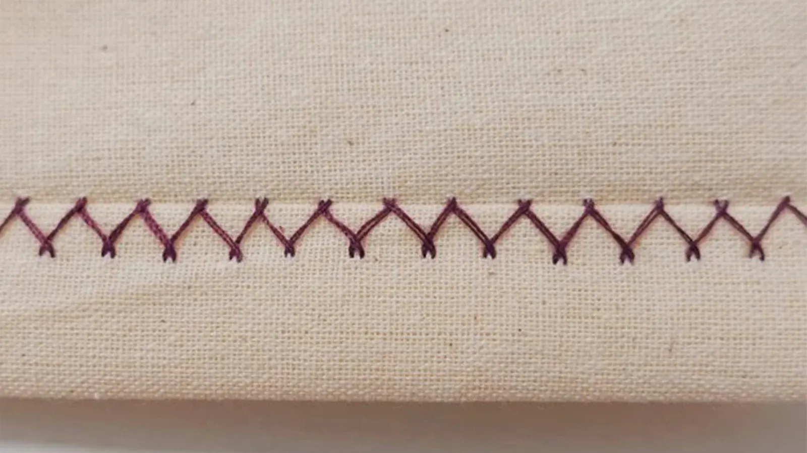 A close up of a fabric with Zigzag Stitches