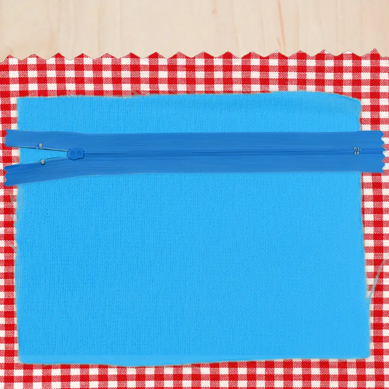 A blue zipper on the lining opening, ready to be inserted.