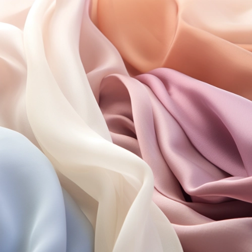 A close up of a pink, blue, and white chiffon fabric, similar to silk.