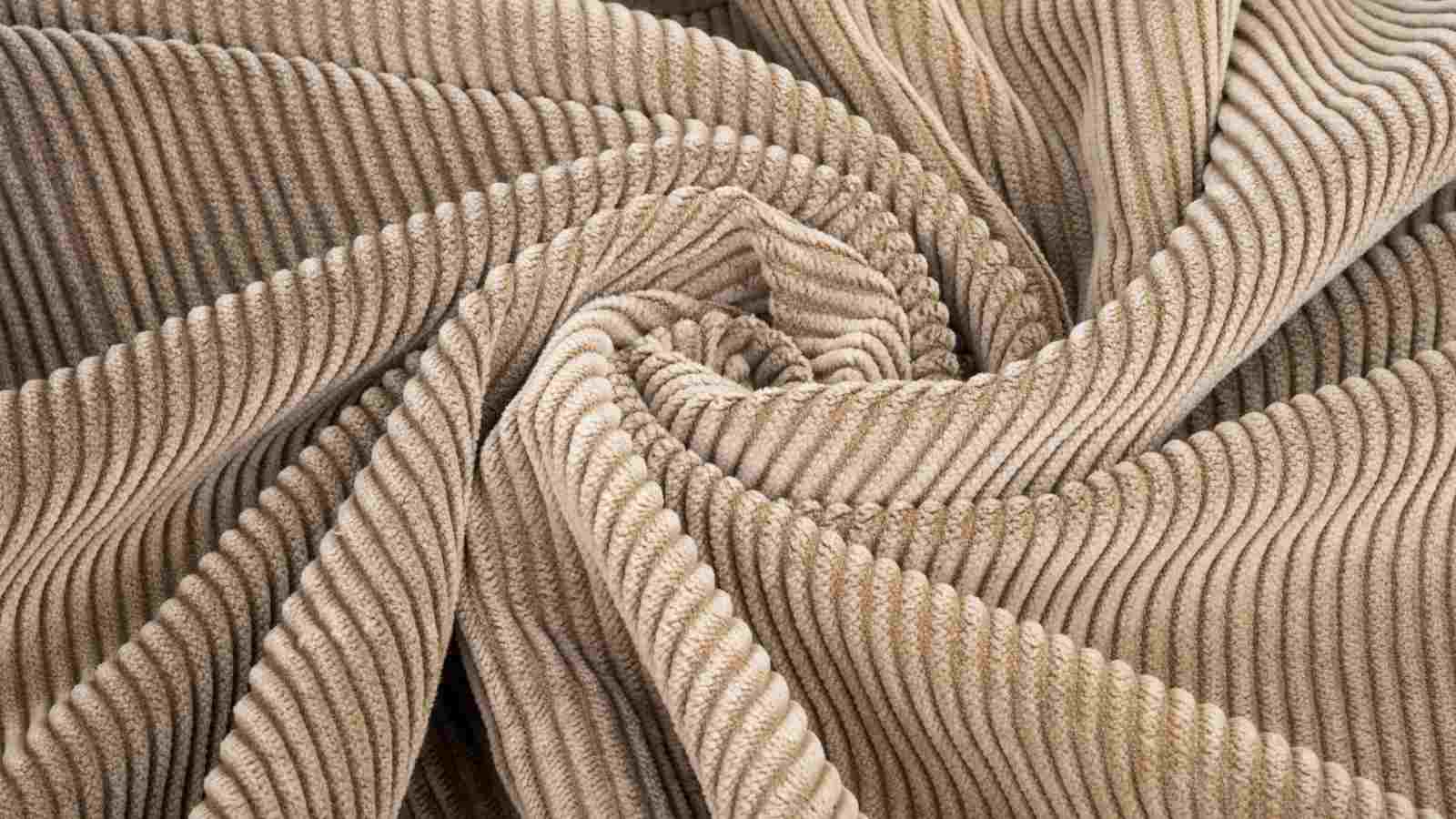 A close up image of a beige corduroy fabric.