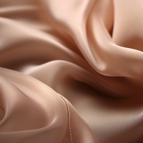 A close up of a beige cupro fabric, similar to silk.
