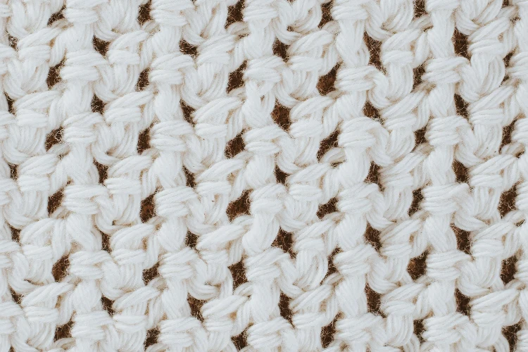 A close up of a white knitted cotton fabric.