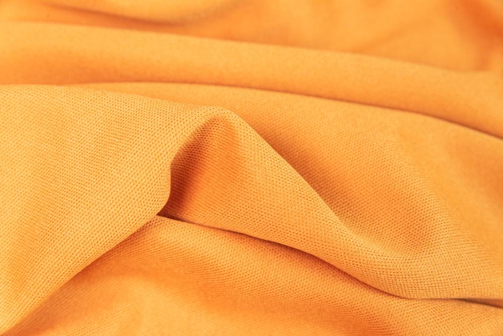 A close up image of an orange terry fabric.