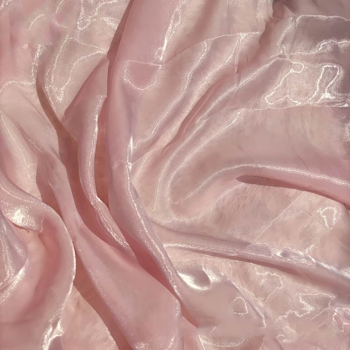A close up of a pink polyester fabric, perfect for a skirt.