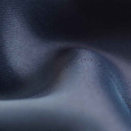 A close up of a dark blue satin fabric, similar to silk.