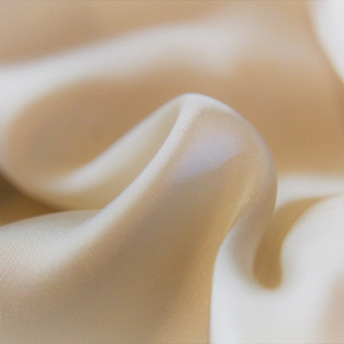 A close up of white satin fabric suitable for pants