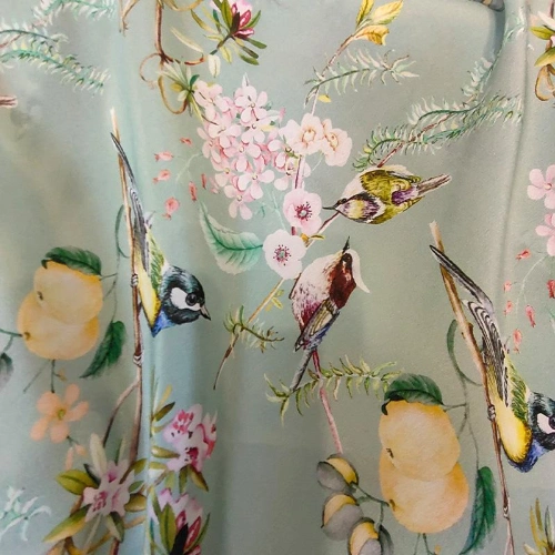 A piece of silk fabric with birds and flowers perfect for skirts