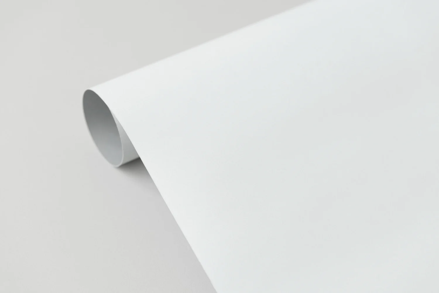 A roll of white paper on a white surface.