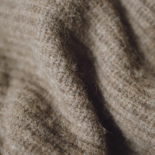 A close up of beige wool fabric perfect for a skirt