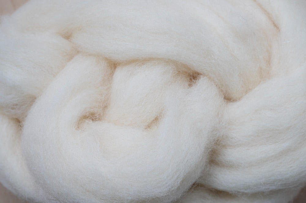 A close up of a ball of white wool.