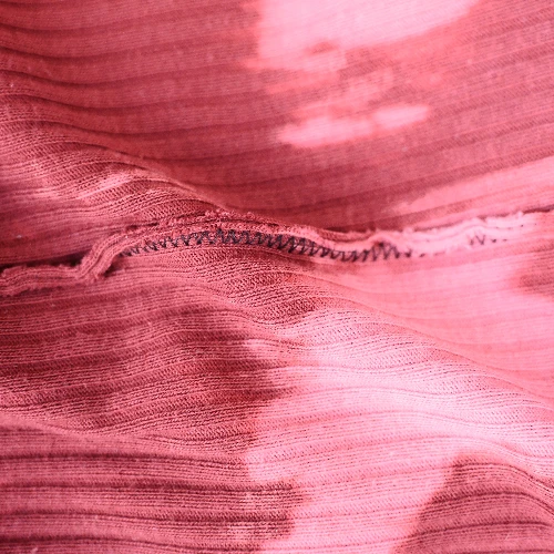 A close up of seam allowances in a pink fabric.